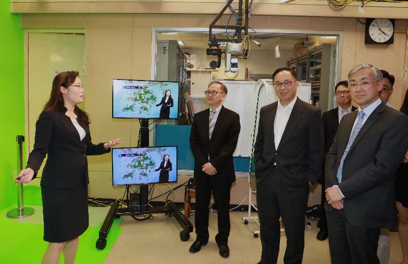 The Secretary for Innovation and Technology, Mr Nicholas W Yang (second right), learns more about the broadcasting of weather reports from Senior Scientific Officer Ms Sandy Song (first left) in the studio of the Hong Kong Observatory (HKO). Also present are the Director of the HKO, Mr Shun Chi-ming (first right), and the Under Secretary for Innovation and Technology, Dr David Chung (second left).