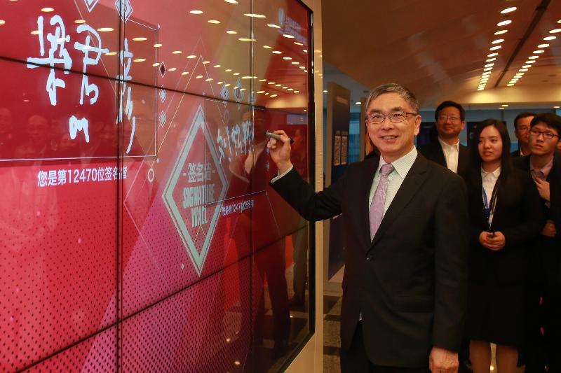The Secretary for Financial Services and the Treasury, Mr James Lau, signing at the Signature Wall of the Shanghai Stock Exchange during his visit with Legislative Council members there today (April 22).